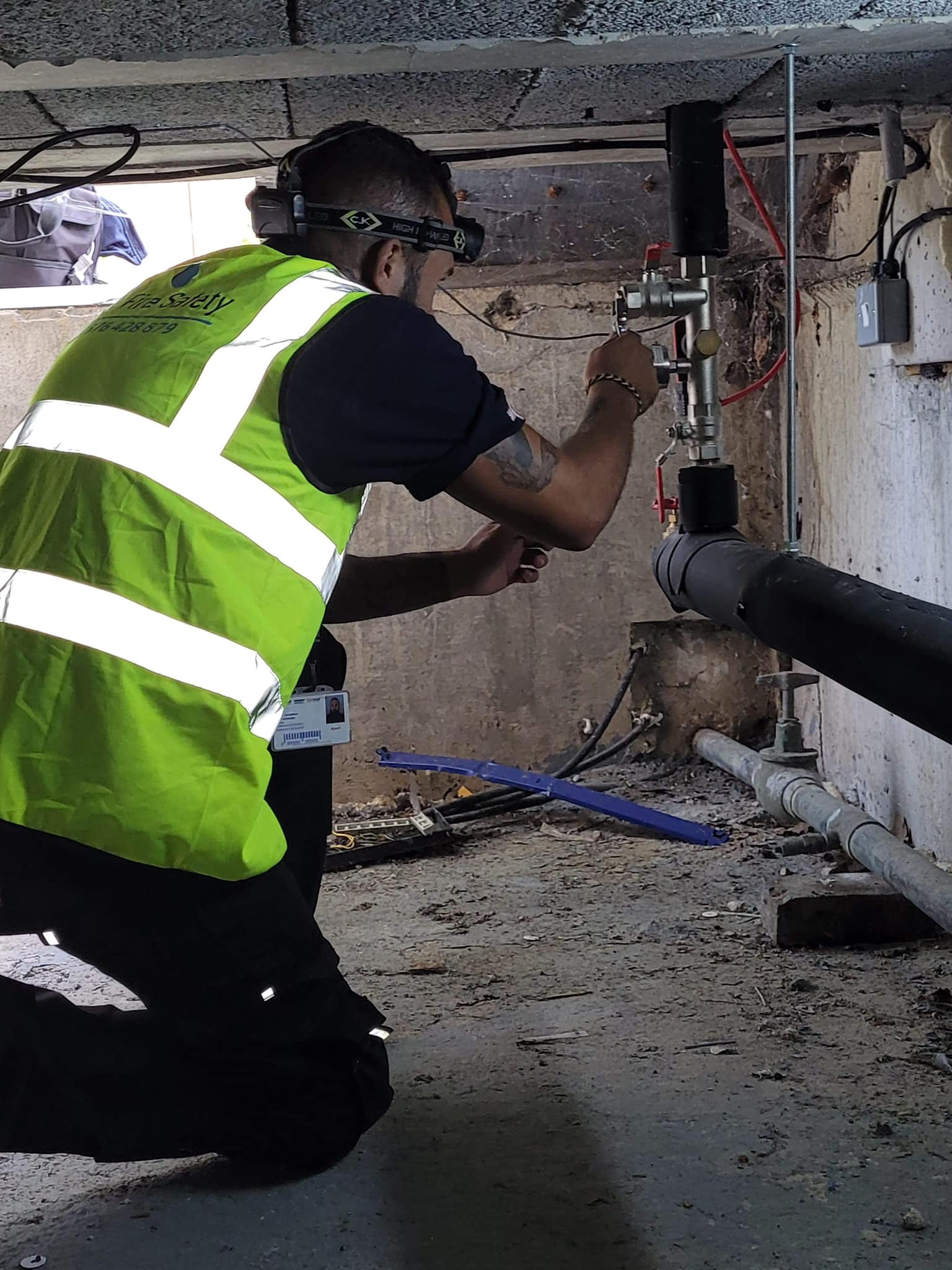 A photo of a man wearing a hi-viz jacket conducting a pipe inspection