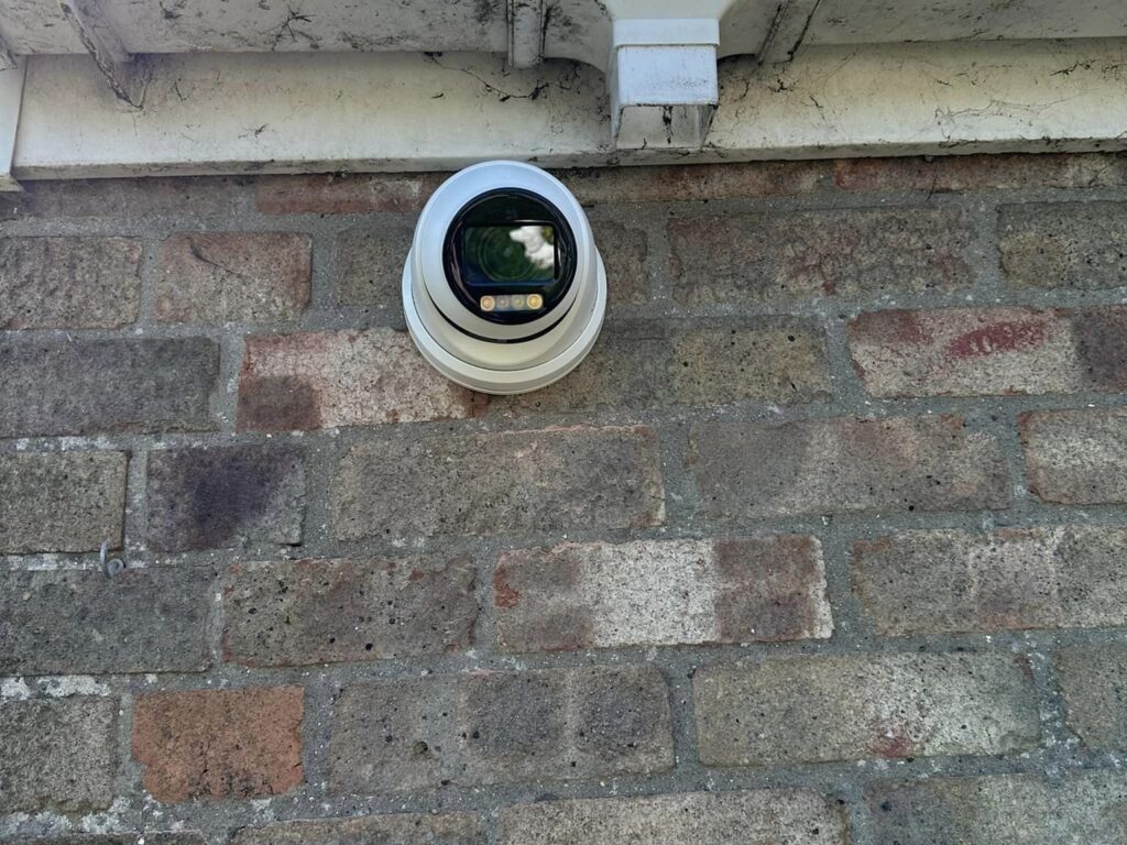 An installation of a security camera on the outside of someone's premises