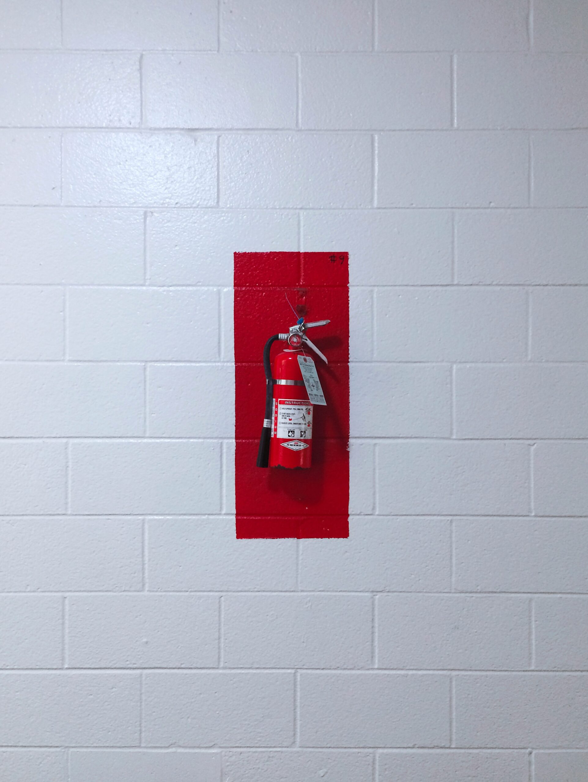 red fire extinguisher on wall